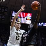 
              Omaha's Wanjang Tut (13) shoots in front of Purdue's Zach Edey (15) during the first half of an NCAA college basketball game in West Lafayette, Ind., Friday, Nov. 26, 2021. (AP Photo/Michael Conroy)
            