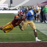 
              UCLA quarterback Dorian Thompson-Robinson, right, runs the ball in for a touchdown as Southern California linebacker Ralen Goforth defends during the first half of an NCAA college football game Saturday, Nov. 20, 2021, in Los Angeles. (AP Photo/Mark J. Terrill)
            