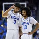 
              UCLA guard Johnny Juzang (3) and guard Tyger Campbell (10) talk during the first half of an NCAA college basketball game against the Long Beach State in Los Angeles, Monday, Nov. 15, 2021. (AP Photo/Ashley Landis)
            