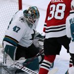 
              San Jose Sharks goaltender James Reimer, left, makes a save on a shot by Chicago Blackhawks left wing Brandon Hagel during the first period of an NHL hockey game in Chicago, Sunday, Nov. 28, 2021. (AP Photo/Nam Y. Huh)
            