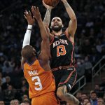 
              New York Knicks' Evan Fournier (13) shoots over Phoenix Suns' Chris Paul (3) during the first half of an NBA basketball game Friday, Nov. 26, 2021, in New York. AP Photo/John Munson)
            