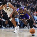 
              Los Angeles Lakers' LeBron James (6) drive against Indiana Pacers' Malcolm Brogdon (7) during the first half of an NBA basketball game, Wednesday, Nov. 24, 2021, in Indianapolis. (AP Photo/Darron Cummings)
            