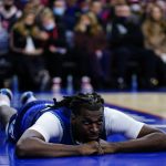 
              Minnesota Timberwolves' Naz Reid lays on the court after a foul during the first half of an NBA basketball game against the Philadelphia 76ers, Saturday, Nov. 27, 2021, in Philadelphia. (AP Photo/Matt Slocum)
            