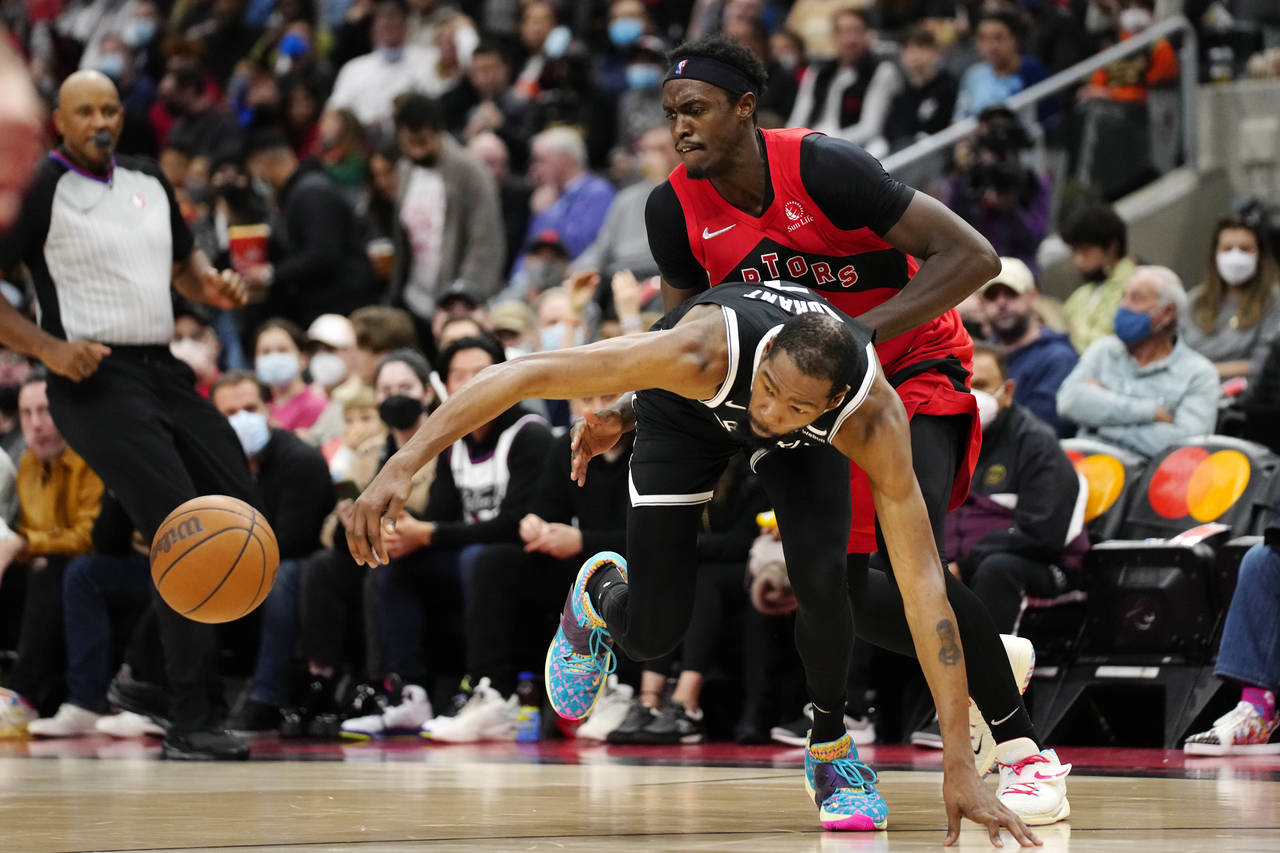 Toronto Raptors forward Pascal Siakam, top, picks up a foul on Brooklyn Nets forward Kevin Durant a...