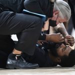 
              Miami Heat forward Markieff Morris, bottom, is attended to after being in an altercation with Denver Nuggets center Nikola Jokic in the second half of an NBA basketball game Monday, Nov. 8, 2021, in Denver. Morris walked off the court after being examined and Jokic was ejected. (AP Photo/David Zalubowski)
            