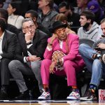 
              Film director Spike Lee, second from right, watches the action during the first half of an NBA basketball game between the Brooklyn Nets and the New York Knicks, Tuesday, Nov. 30, 2021, in New York. (AP Photo/Mary Altaffer)
            