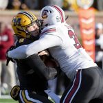 
              Missouri quarterback Connor Bazelak, left, is sacked by South Carolina linebacker Damani Staley, right, during the first quarter of an NCAA college football game Saturday, Nov. 13, 2021, in Columbia, Mo. (AP Photo/L.G. Patterson)
            