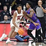 
              Louisville guard Dre Davis (14) drives on Furman guard Alex Hunter during the first half of an NCAA college basketball game in Louisville, Ky., Friday, Nov. 12, 2021. (AP Photo/Timothy D. Easley)
            