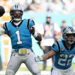 
              Carolina Panthers quarterback Cam Newton (1) aims a pass as running back Christian McCaffrey (22) defends, during the first half of an NFL football game against the Miami Dolphins, Sunday, Nov. 28, 2021, in Miami Gardens, Fla. (AP Photo/Wilfredo Lee)
            