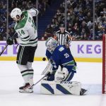 
              Vancouver Canucks goalie Thatcher Demko (35) makes the save as Dallas Stars' Jamie Benn (14) attempts to redirect the puck during the third period of an NHL hockey game in Vancouver, British Columbia, Sunday, Nov. 7, 2021. (Darryl Dyck/The Canadian Press via AP)
            