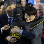 
              Joel Rosario, center, is congratulated by Lee Jinwoo, senior manager from Korea Racing Authority, right, after riding Knicks Go to victory during the Breeders' Cup Classic race at the Del Mar racetrack in Del Mar, Calif., Saturday, Nov. 6, 2021. (AP Photo/Jae C. Hong)
            