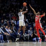 
              Xavier's Nate Johnson attempts a three-point basket against Ohio State's Malachi Branham (22) during the second half of an NCAA college basketball game, Thursday, Nov. 18, 2021, in Cincinnati. (AP Photo/Aaron Doster)
            