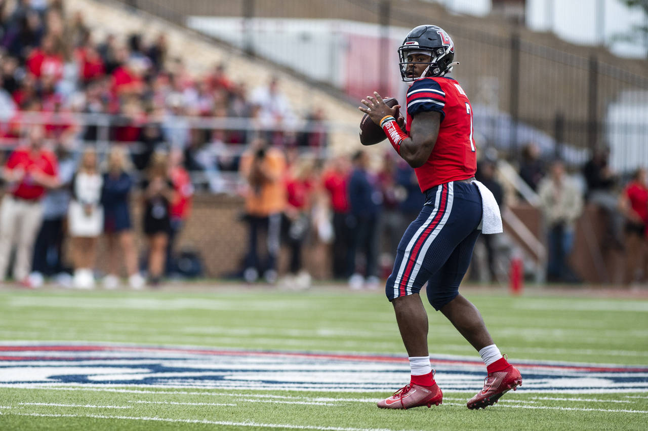 Liberty quarterback Malik Willis looks for a receiver during an NCAA college football game against ...