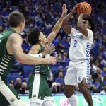
              Kentucky's Sahvir Wheeler (2) shoots while defended by Jason Carter, left, and Mark Sears (1) during the first half of an NCAA college basketball game in Lexington, Ky., Friday, Nov. 19, 2021. (AP Photo/James Crisp)
            