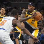 
              Indiana Pacers' Torrey Craig (13) goes to the basket against New York Knicks' Kemba Walker (8) during the second half of an NBA basketball game Wednesday, Nov. 3, 2021, in Indianapolis. Indiana won 111-98. (AP Photo/Darron Cummings)
            
