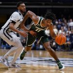 
              Michigan State guard A.J. Hoggard (11) drives away from Butler guard Aaron Thompson (2) in the second half of an NCAA college basketball game in Indianapolis, Wednesday, Nov. 17, 2021. Michigan State defeated Butler 73-52. (AP Photo/Michael Conroy)
            
