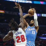
              Los Angeles Clippers forward Paul George (13) shoots against Detroit Pistons forward Isaiah Stewart (28) during the second half of an NBA basketball game, Friday, Nov. 26, 2021, in Los Angeles. (AP Photo/Ringo H.W. Chiu)
            