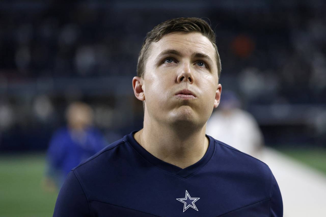 Dallas Cowboys offensive coordinator Kellen Moore walks off the field after an overtime loss to the...