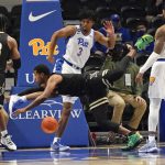 
              Vanderbilt's Jordan Wright, center, tumbles as he tries for a rebound with Pittsburgh's Noah Collier (3) during the first half of an NCAA college basketball game, Wednesday, Nov. 24, 2021, in Pittsburgh. (AP Photo/Keith Srakocic)
            