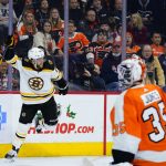 
              Boston Bruins' David Pastrnak, left, celebrates after scoring a goal against Philadelphia Flyers' Martin Jones during the third period of an NHL hockey game, Saturday, Nov. 20, 2021, in Philadelphia. (AP Photo/Matt Slocum)
            