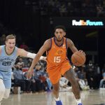 
              Phoenix Suns' Cameron Payne (15), heads for the basket as Memphis Grizzlies' Mikal Bridges (25) defends in the second half of an NBA basketball game Friday, Nov. 12, 2021, in Memphis, Tenn. (AP Photo/Karen Pulfer Focht)
            