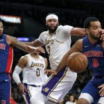 
              Los Angeles Lakers forward Anthony Davis, center, gets a piece of Detroit Pistons forward Trey Lyles, right, knocking the ball away with guard Cory Joseph, left, looking on during the first half of an NBA basketball game Sunday, Nov. 28, 2021, in Los Angeles. (AP Photo/Alex Gallardo)
            