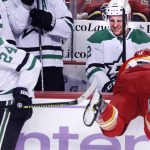
              Calgary Flames' Mikael Backlund, right, from Sweden, is knocked into the Dallas Stars bench by Stars' Roope Hintz during the first period of an NHL hockey game Thursday, Nov. 4, 2021, in Calgary, Alberta. (Larry MacDougal/The Canadian Press via AP)
            