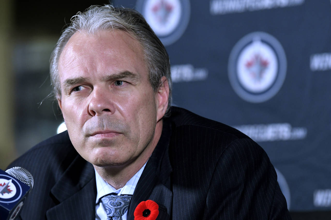 Winnipeg Jets general manager Kevin Cheveldayoff listens to reporters' questions during a news conf...