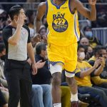
              Golden State Warriors forward Andrew Wiggins (22) gestures after scoring against the Toronto Raptors during the first half of an NBA basketball game in San Francisco, Sunday, Nov. 21, 2021. (AP Photo/Jeff Chiu)
            