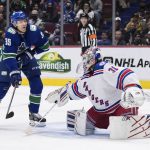 
              Vancouver Canucks' Alex Chiasson, left, is struck by the puck as he attempts to redirect it in front of New York Rangers goalie Igor Shesterkin during the second period of an NHL hockey game Tuesday, Nov. 2, 2021, in Vancouver, British Columbia. (Darryl Dyck/The Canadian Press via AP)
            