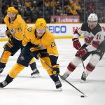 
              Nashville Predators right wing Eeli Tolvanen (28) moves the puck ahead of New Jersey Devils left wing Andreas Johnsson (11) in the second period of an NHL hockey game Friday, Nov. 26, 2021, in Nashville, Tenn. (AP Photo/Mark Humphrey)
            