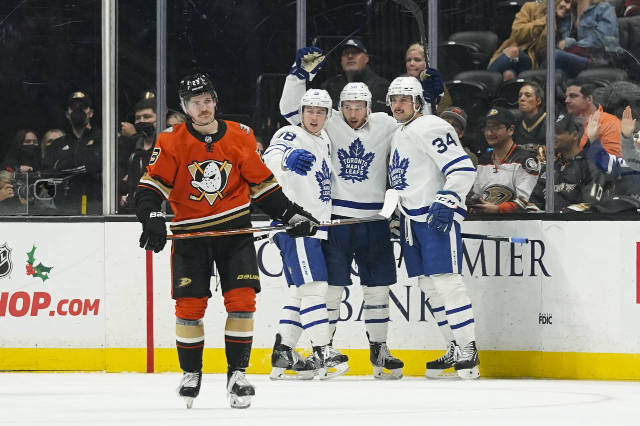 Toronto Maple Leafs' Auston Matthews, from right, Michael Bunting and Mitchell Marner celebrate a g...
