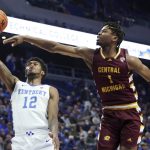
              Kentucky's Keion Brooks Jr. (12) shoots while pressured by Central Michigan's Ralph Bissainthe (1) during the first half of an NCAA college basketball game in Lexington, Ky., Monday, Nov. 29, 2021. (AP Photo/James Crisp)
            