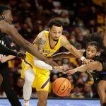 
              Minnesota guard Payton Willis (0) drives through the defense of Purdue Fort Wayne guard Damian Chong Qui (2) and forward Ra Kpedi (3) in the second half of an NCAA college basketball game, Friday, Nov. 19, 2021, in Minneapolis. (AP Photo/Andy Clayton-King)
            