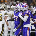 
              Buffalo Bills defensive end Mario Addison (97) celebrates a defensive stop with teammates as New Orleans Saints quarterback Trevor Siemian (15) walks off the field in the first half of an NFL football game in New Orleans, Thursday, Nov. 25, 2021. (AP Photo/Butch Dill)
            