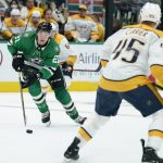 
              Dallas Stars left wing Jason Robertson (21) works against Nashville Predators defenseman Alexandre Carrier (45) as he advances the puck in the first period of an NHL hockey game in Dallas, Wednesday, Nov. 10, 2021. (AP Photo/Tony Gutierrez)
            