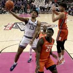 
              Kansas State's Mark Smith (13) shoots over Illinois' Kofi Cockburn (21) during the first half of an NCAA college basketball game Tuesday, Nov. 23, 2021, in Kansas City, Mo. (AP Photo/Charlie Riedel)
            