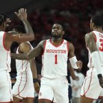 
              =Houston guard Jamal Shead (1) is congratulated by teammates after his dunk against Rice during the first half of an NCAA college basketball game Friday, Nov. 12, 2021, in Houston. (AP Photo/Justin Rex)
            