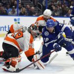 
              Philadelphia Flyers goaltender Carter Hart (79) stops a shot by Tampa Bay Lightning right wing Taylor Raddysh (16) during the second period of an NHL hockey game Tuesday, Nov. 23, 2021, in Tampa, Fla. (AP Photo/Chris O'Meara)
            