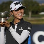 
              Lydia Ko, of New Zealand, holds the Care trophy for the lowest scoring average after the final round of the LPGA Tour Championship golf tournament, Sunday, Nov. 21, 2021, in Naples, Fla. (AP Photo/Rebecca Blackwell)
            