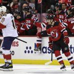 
              New Jersey Devils left wing Andreas Johnsson (11) reacts after scoring a goal behind Florida Panthers center Aleksander Barkov during the second period of an NHL hockey game Tuesday, Nov. 9, 2021, in Newark, N.J. (AP Photo/Adam Hunger)
            