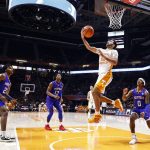 
              Tennessee guard Santiago Vescovi (25) goes for a reverse layup past Presbyterian guard Rayshon Harrison (0) during an NCAA college basketball game Tuesday, Nov. 30, 2021, in Knoxville, Tenn. (AP Photo/Wade Payne)
            