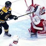 
              Detroit Red Wings goaltender Thomas Greiss (29) deflects the puck while pressured by Boston Bruins left wing Taylor Hall (71) during the first period of an NHL hockey game Thursday, Nov. 4, 2021, in Boston. (AP Photo/Charles Krupa)
            