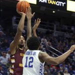 
              Central Michigan's Aundre Polk, left, shoots while pressured by Kentucky's Keion Brooks Jr. (12) during the second half of an NCAA college basketball game in Lexington, Ky., Monday, Nov. 29, 2021. Kentucky won 85-57. (AP Photo/James Crisp)
            