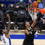 
              Vanderbilt's Tyrin Lawrence (0) puts up a layup after hitting past Pittsburgh's Jamarius Burton (11) during the first half of an NCAA college basketball game, Wednesday, Nov. 24, 2021, in Pittsburgh. (AP Photo/Keith Srakocic)
            