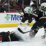 
              While covering up the puck, Arizona Coyotes goalie Scott Wedgewood (31) gets a face full of ice shavings  from Dallas Stars' Joe Pavelski (16) and Coyotes' Kyle Capobianco (75) during the second period of an NHL hockey game Saturday, Nov. 27, 2021, in Glendale, Ariz. (AP Photo/Darryl Webb)
            