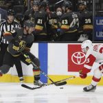 
              Vegas Golden Knights defenseman Brayden McNabb (3) grabs the puck against Detroit Red Wings right wing Lucas Raymond (23) during the second period of an NHL hockey game Thursday, Nov. 18, 2021, in Las Vegas. (AP Photo/Joe Buglewicz)
            
