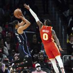 
              Orlando Magic guard R.J. Hampton (13) shoots as Atlanta Hawks guard Delon Wright (0) defends in the second half of an NBA basketball game Friday, Nov. 15, 2021, in Atlanta. (AP Photo/John Bazemore)
            