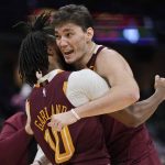 
              Cleveland Cavaliers' Cedi Osman, right, hugs Darius Garland after the Cavaliers defeated the Boston Celtics 91-89 in an NBA basketball game, Saturday, Nov. 13, 2021, in Cleveland. (AP Photo/Tony Dejak)
            