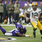 
              Green Bay Packers quarterback Aaron Rodgers (12) runs from Minnesota Vikings defensive tackle Dalvin Tomlinson (94) during the second half of an NFL football game, Sunday, Nov. 21, 2021, in Minneapolis. (AP Photo/Bruce Kluckhohn)
            